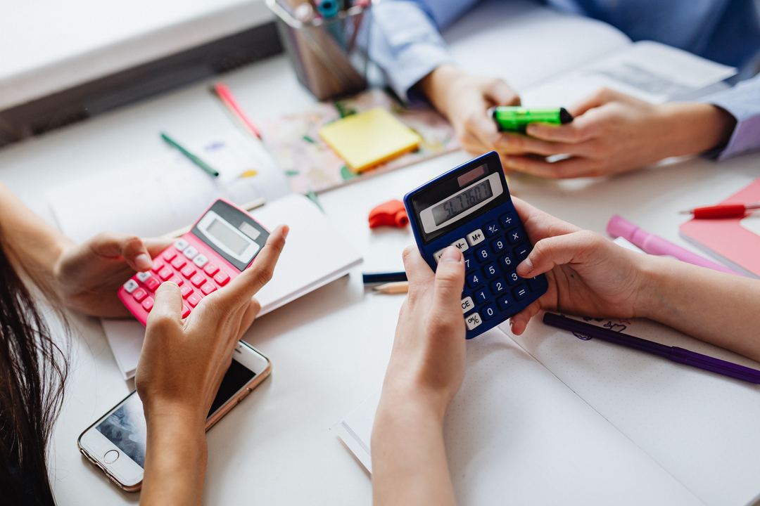 Students checking answers with calculators